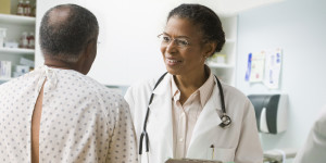 Female doctor speaking to male patient